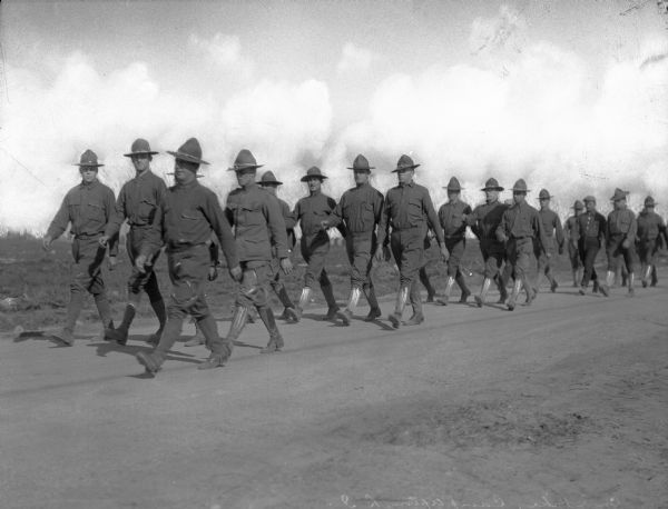 Rows of soldiers march down a dirt road at Camp Upton, on which construction began in 1917.