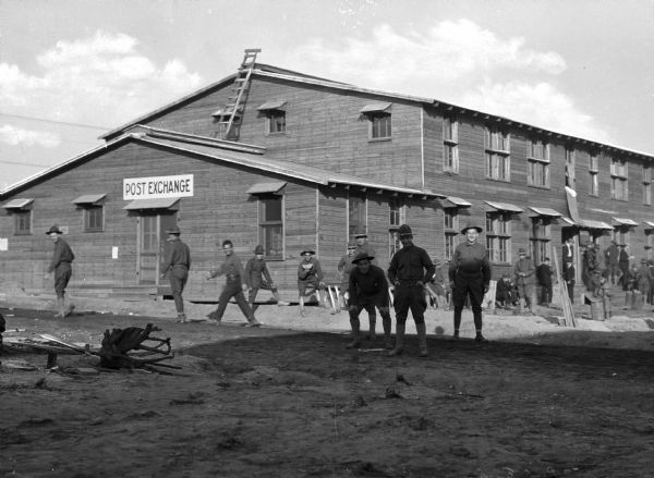 Men stand outside the Post Exchange Store at Camp Upton, built in 1917.