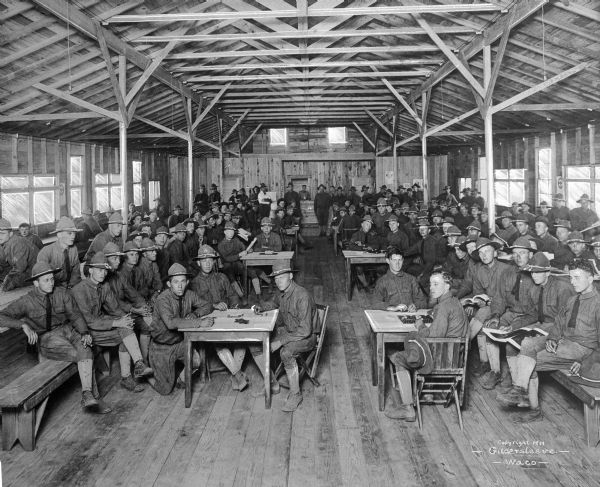 An interior view of soldiers gathered in the Y.M.C.A. game room at Camp MacArthur, on which construction began in 1917.