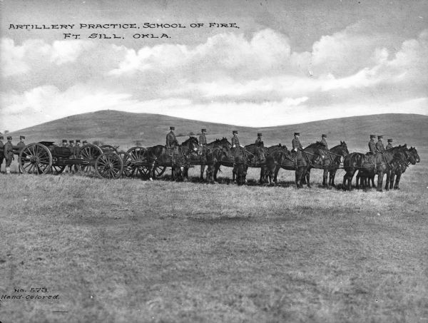 A view of horse-drawn artillery at the School of Fire, established in 1911 at Fort Sill. Caption reads: "Artillery Practice, School of Fire, Ft. Sill, OKLA."