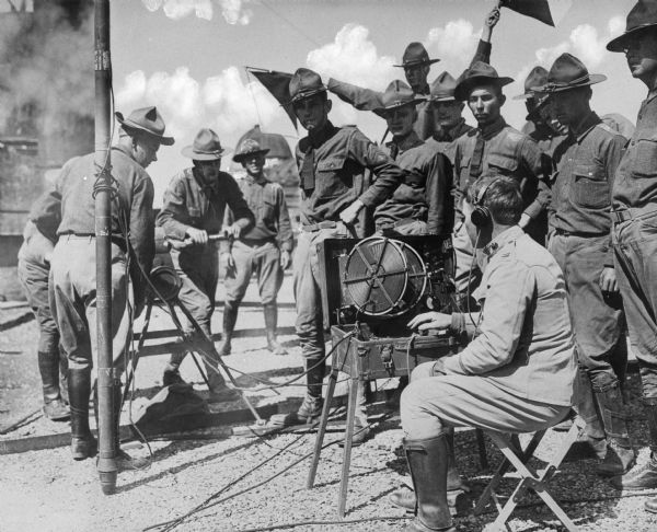 A view of uniformed men gathering around an Army field wireless station at Camp Bowie, built in 1917.