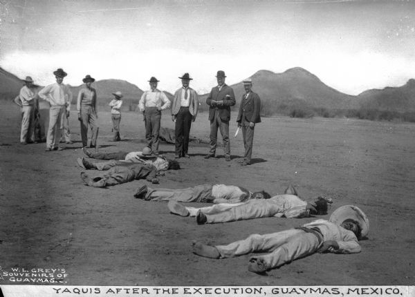 A view of members of the Yaqui tribe after the execution of six men in Guaymas Mexico. Caption reads: "Yaquis after the execution, Guaymas, Mexico."