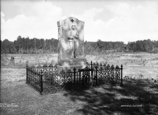 View of a monument to New Jersey's Fifteenth Regiment on the site of a battlefield. The memorial was erected by the State of New Jersey and is surrounded by a fence.