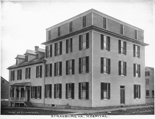 Exterior of Strasburg Hospital. The four-story structure on the right was attached to the large house on the left around 1902. Caption reads: "Strasburg, VA., Hospital."
