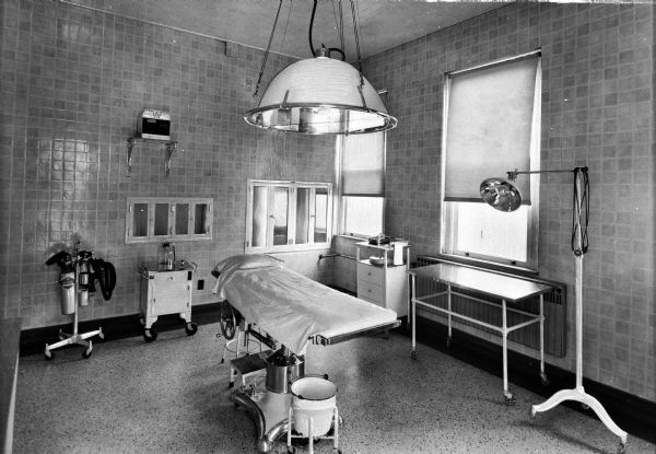 Interior of an operating room at Saint Mary's Hospital, completed May 18, 1859 and designed by Anthony Bley. An operating table, lights, and other surgical equipment can be seen in the room.