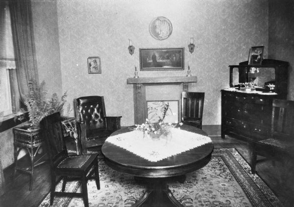 Interior of a sitting place at Saint Mary's Sanatorium, founded in 1880 by Bishop Salpointe. The room holds chairs and tables, and decorative art lines the walls.