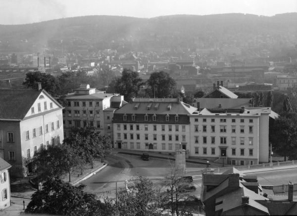 Elevated view of the Moravian Center. On the left is the Central Moravian Church, constructed between 1803 and 1806, and on the right stands the Moravian College and Seminary for Women. In the background is the Bethlehem Steel Company, and Lehigh University is built into the hillside.