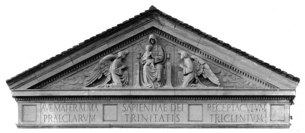 View of a bas-relief sculpture on a pediment of a building.  The top features two angels on each side of Mary and Jesus.  Text below the sculpture reads, "Ave Mater Alma Praeclarum," "Sapientiae Dei Trinitatis" and "Receptacuium Triclinium."