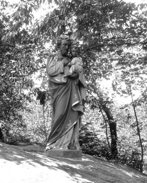 View of a statue of a man and child in the garden at the College of the Sacred Heart, founded in 1841.