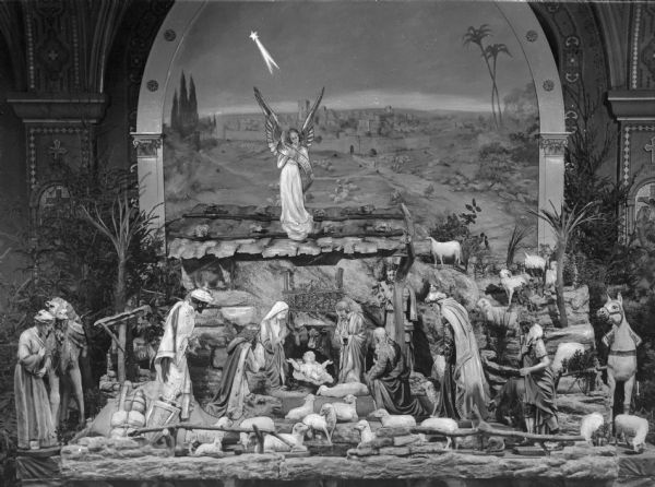 View of a scene of the nativity in Bethlehem at Saint Anthony's Shrine, also called 'Mount Airy,' consecrated in 1889.  The scene features the Holy Family, shepherds, and animals.  On top of the manger stands an angel near a shooting star.