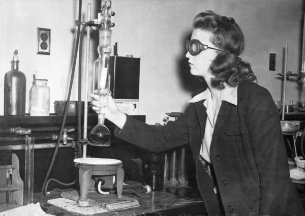 A female student wearing goggles uses the equipment in the Organic Chemistry Laboratory of Westminster College, established on January 21, 1852.
