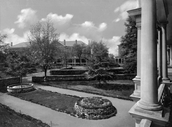 View from the porch of Upshaw Hall toward the lawns and gardens of the campus of Bessie Tift College, founded in 1849. Tift Hall stands on the left, and Ponder Hall is on the right.