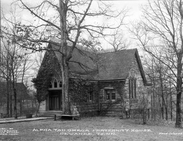 Exterior of Alpha Tau Omega fraternity house, built in 1880. The chapter house was built on the campus of the University of the South, founded in 1865. The small, stone house stands in a wooded area. Caption reads: "Alpha Tau Omega Fraternity House, Sewanee, Tenn."