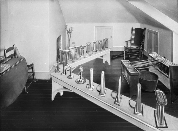 Interior of the Morris-Jumel Mansion, also known as Washington's Headquarter's, built in 1765 by Colonel Roger Morriw and Mary Philipse. The view includes candle-making equipment and candle holders on tables.