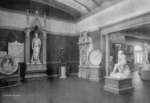 Interior of Parrish Art Museum, built in 1898. The gallery features many sculptures and opens to another room on the right.