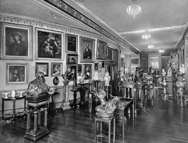 Interior of the art gallery at Marywood College, established in 1914.  Paintings hang on the walls and sculptures stand in the gallery.