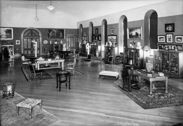 Interior of the library at the School of the Brown County Ursulines, established by the Ursuline Sisters, founded in 1845.  Bookshelves and windows line the right wall, and chairs and tables can be found in the center of the room.