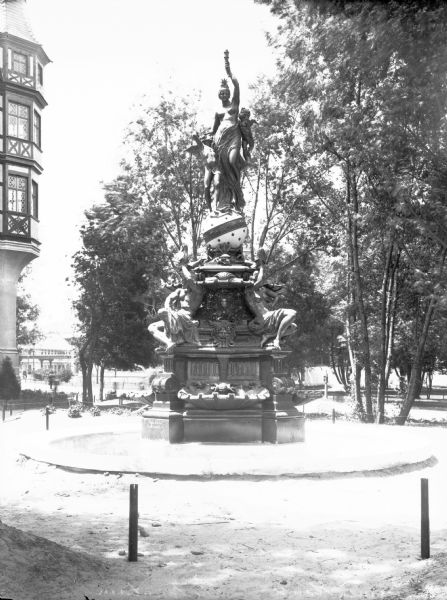 View of the sculpture for the Columbian Exposition, celebrating the 400th anniversary of Christopher Columbus’s voyage to America. A male and a female are at the base, and a woman and children are at the top of the sculpture.