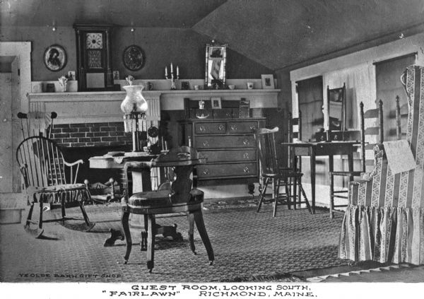 View looking south inside a guest room at 'Fairlawn' Hotel (?).  The room features tables, chairs, and decorative items above a fireplace.  Published by Ye Olde Barn Gift Shop.