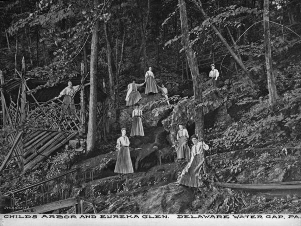 Women stand on a hillside at Child's Arbor and Eureka Glen, land purchased by George W. Childs in 1927. On the hill above them is a bridge. Caption reads: "Childs Arbor and Eureka Glen. Delaware Water Gap, PA."