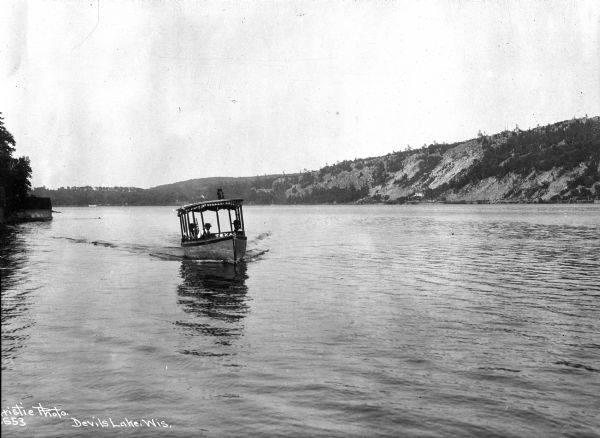 View of the "Texas,, a small boat carrying three passengers on Devil's Lake.