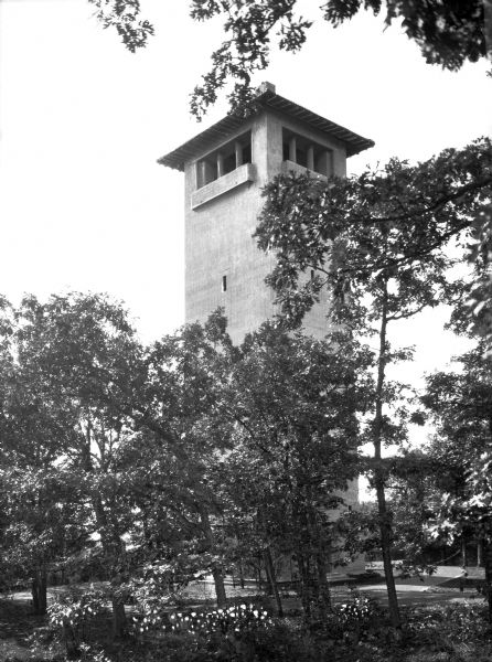 Trees and flowers surround the rectangular tower at Lawsonia Country Club. The country club opened to the public in 1930.