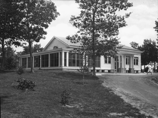 Exterior of Tuscumbia Country Club, founded in 1896. The building features a pillared side entrance and large windows.