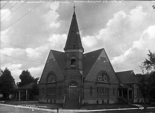 Front view of Saint Paul's Methodist Episcopal Church, dedicated on December 7, 1890. The church features a central tower and elaborate stained glass windows and is located on the northeast corner of Strongs Avenue and Brawley Street.