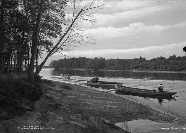 Individuals use rowboats near the shore of Marlin's Island on the Wisconsin River.