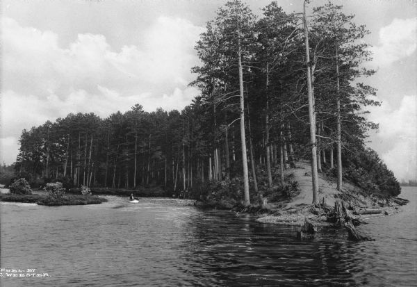 A man boats near the shoreline at Prospect Point.  Prospect Point consolidated with Hog's Back in 1910 to form 105 acres of land and was renamed Bradley Park.  Published by J. C. Webster.