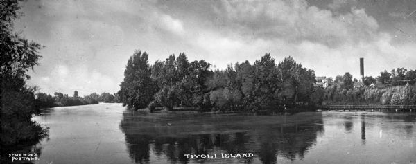 View of Tivoli Island, situated in the Rock River. A bridge spans from the island to the river bank on the right. Caption reads: "Tivoli Island."