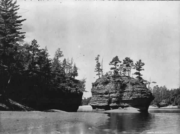 View of the Sugar Bowl rock formation on the Wisconsin River.  The photograph caption reads "Camera Works by Sweet MPLS."