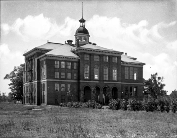 View of Old Lincoln High School. The building was built in 1903 and features an arched entrance and central cupola.