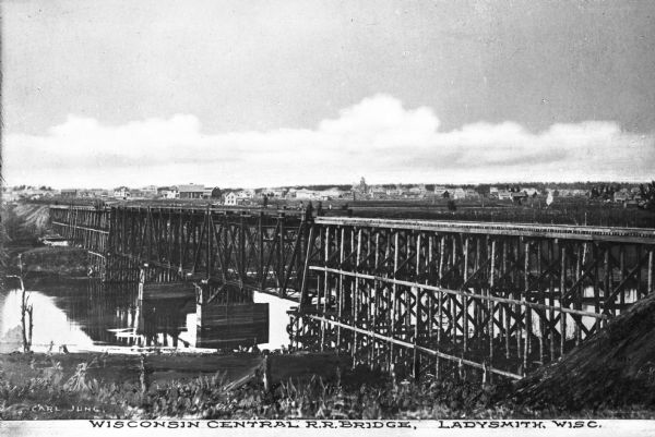 Elevated view of the Wisconsin Central Railroad Bridge. Wisconsin Central Railroad Company was incorporated in February 1871. Caption reads: "Wisconsin Central R. R. Bridge, Ladysmith, Wisc."