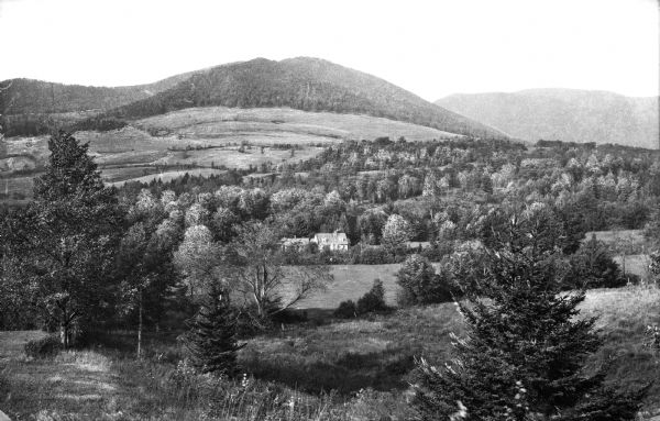 View of the Fahnestock House with Saddleback Mountain in the background.