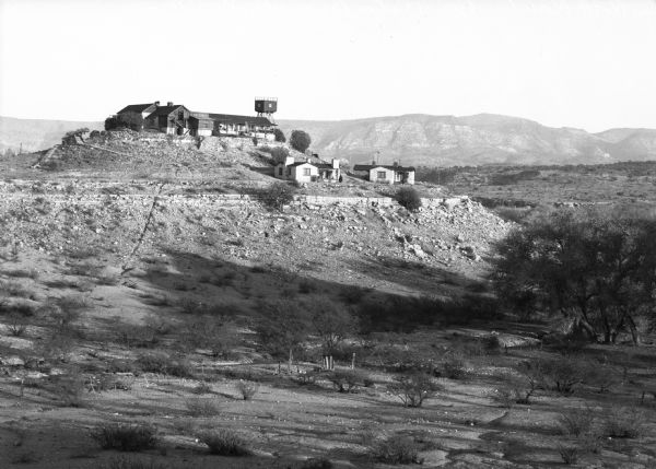 View of Rimrock Ranch. Buildings are on top of a hill.