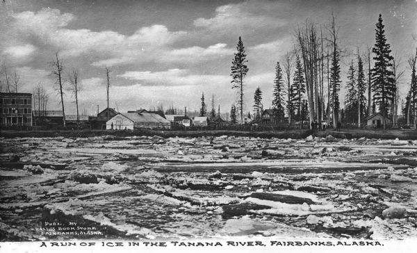 Ice in the Tanana River. Buildings are along the shore in the background. Caption reads: "A Run of Ice in the Tanana River, Fairbanks, Alaska."
