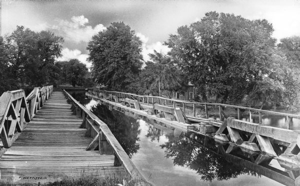 View of the Morris Canal Aqueduct, with a wooden walkway bridge beside it on the left.