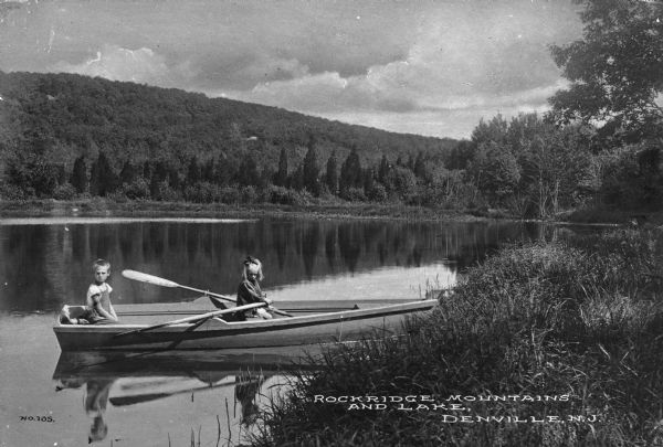Lake scene with children in a rowboat near the Rock Ridge Mountains and Lake. Caption reads: "Rockridge Mountains and Lake, Denville, N.J."
