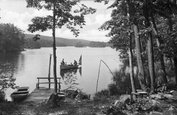 View of a family boating in the west side cove on Beaver Lake.