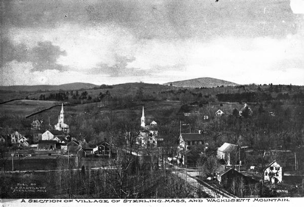 Church steeples and village dwellings are visible amidst trees, backed by the Wachusett Mountain. Published by E.P. Bartlett.