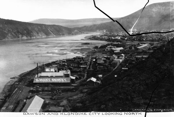 Elevated view of Dawson and Klondike City, looking north. Klondike Brewery is labeled in the foreground at left. Published by Landahl's Emporium.