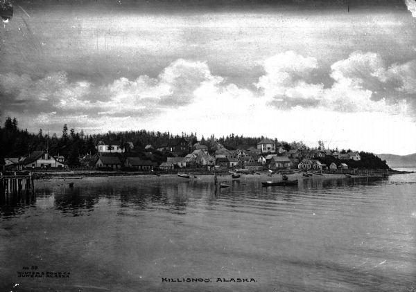 City view from the water.  Boats can be seen near piers along the shoreline.  Published by Winter & Pond Co. Juneau, Alaska.