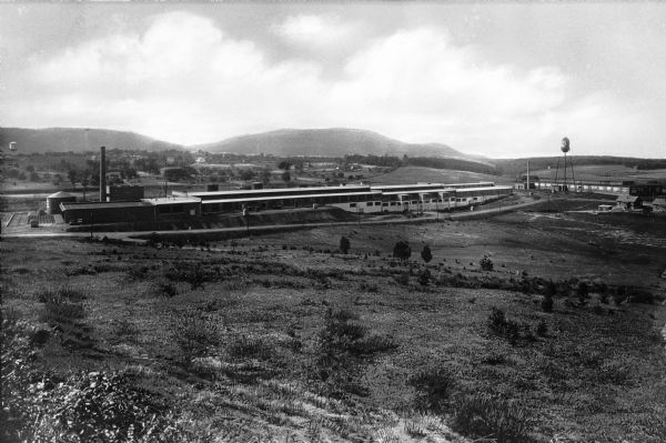 View across an open field looking toward Bald Mountain Furniture Company and Angle Silk Mills Plant.
