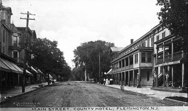 VIew down Main Street featuring County Hotel.  Published by E. Vosseller, Stationer.