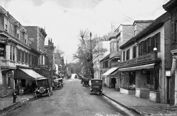 View down King Street featuring automobiles parked outside storefronts.