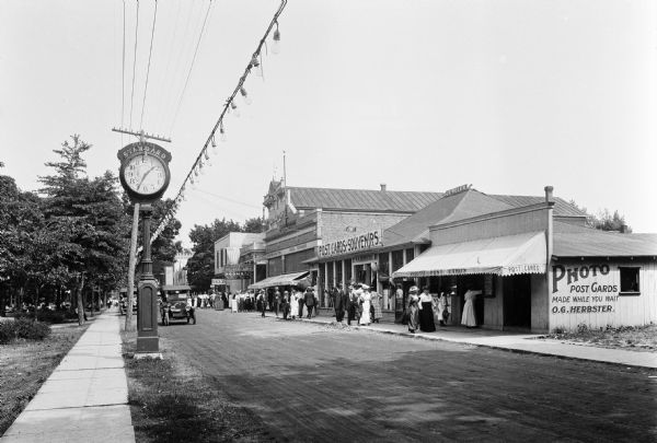 View of O.G. Herbster's Souvenir and Post Card Shop as seen from from across a street.  The Central Standard clock stands at left.