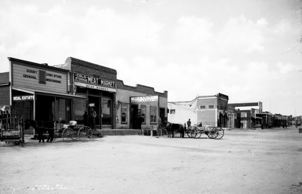 View down East Main Street featuring several storefronts. Published by S. Friedman.