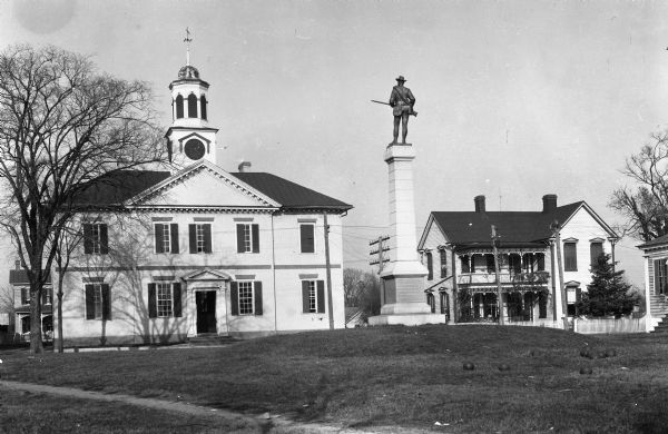 View of Chowan County Courthouse, built in 1767 by architect John Hawks. The Georgian building features a central cupola and clock tower. A Confederate monument with a soldier atop it stands outside the courthouse.