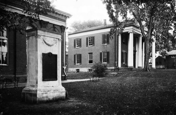 View of a World War I Monument outside of the County Clerk's Office.  To the left of the colonnaded Clerk's Office, the Old Courthouse, built in 1895, can be seen.